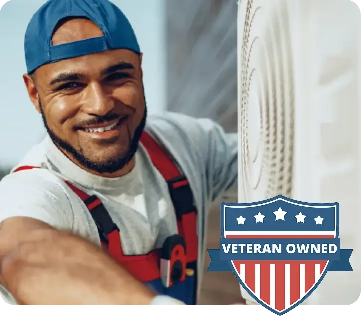 Technician servicing an outdoor AC unit, veteran-owned badge